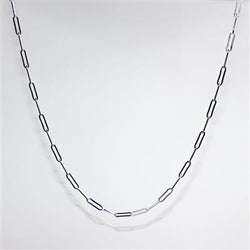 Silver chain necklace on a light gray background