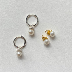 Mini Pearl charms with silver waves hang from Sterling Silver hoops.