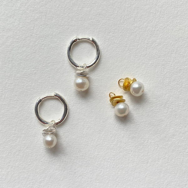 Mini Pearl charms with silver waves hang from Sterling Silver hoops.