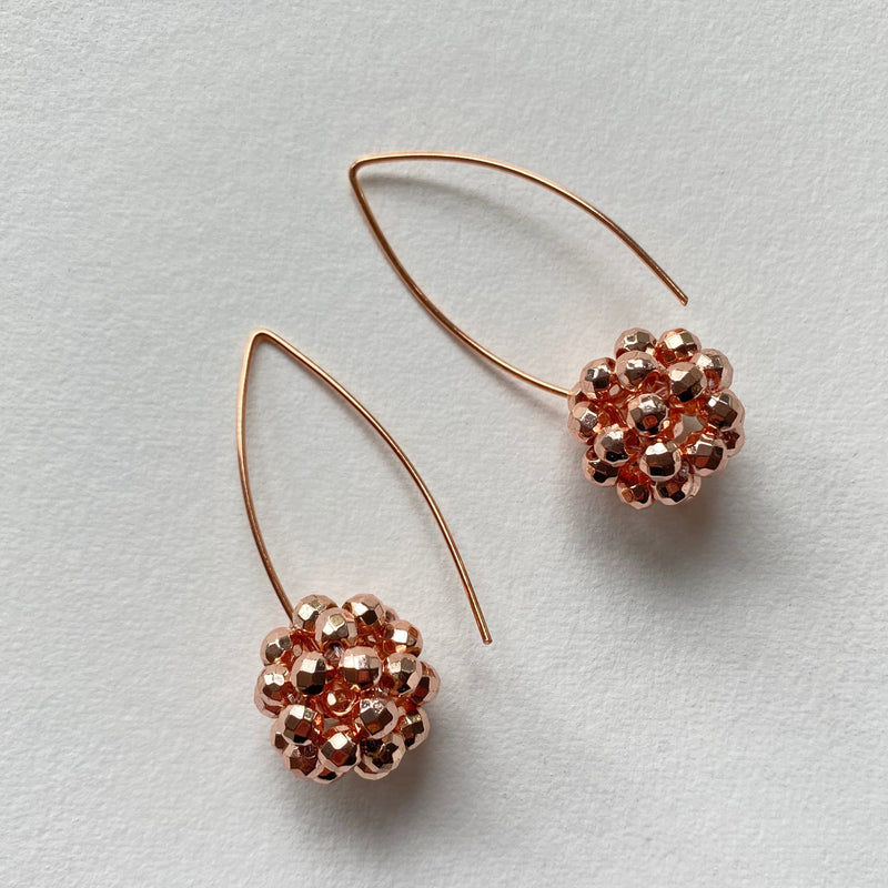 Rose gold handcrafted lace balls hang from a rose gold plated long hook. Fabulous statement earrings.
